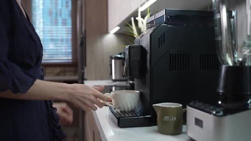 Woman Making Coffee with Coffee Machine at Home