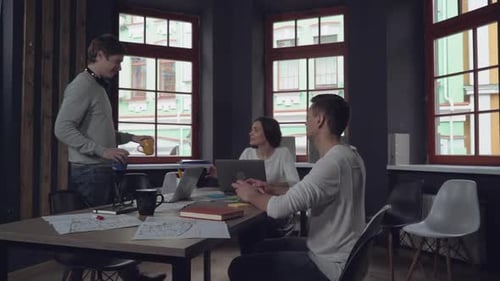 Adult Guy Holding Two Cups Coming in Office