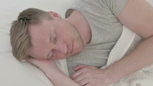 Man Asleep in Bed Top View