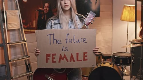 Young Woman Holding Sign Indoors