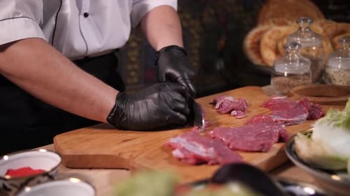 Chef Expertly Slicing Fresh Meat for Gourmet Meal