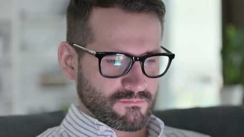 Close Up of Face of Young Man Using Digital Device at Home