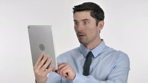 Man Reacting in Shock to Content on Tablet