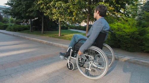 Wheelchair User Is Driving Down the Street