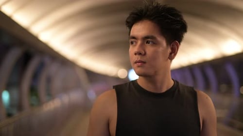 Portrait of Young Handsome Asian Man Thinking Outdoors at Night