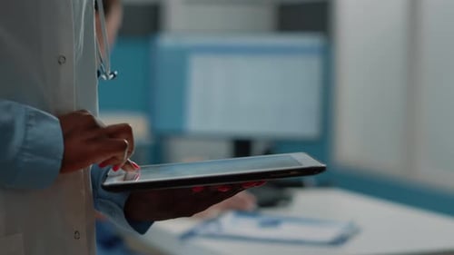 Close Up of African American Doctor Using Digital Tablet