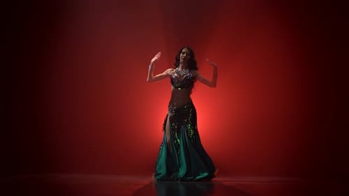 Woman Performing Belly Dance on Red Background