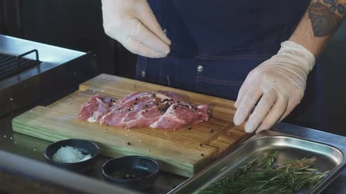 Chef Seasoning Raw Meat with Salt