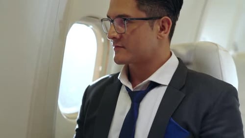 Young Adult Working on Laptop During Flight