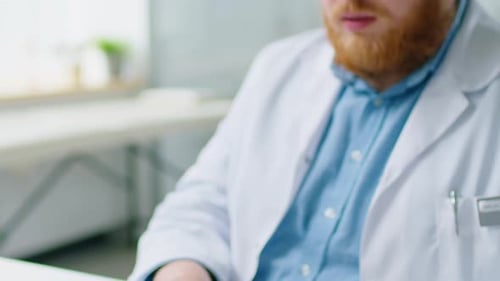 Doctor Using Computer during Workday
