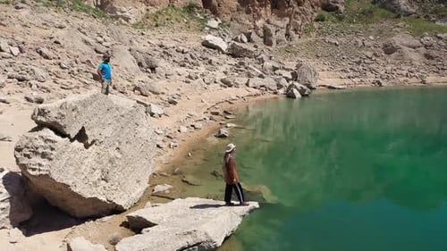 Two People Watching The Lake