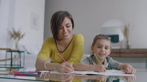 Mother and Child Coloring Together at Home