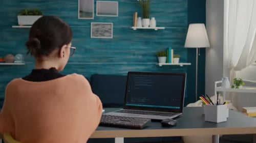 Woman Typing on Laptop at Home Office Desk