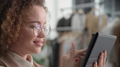 Young Woman Uses Tablet in Modern Workplace