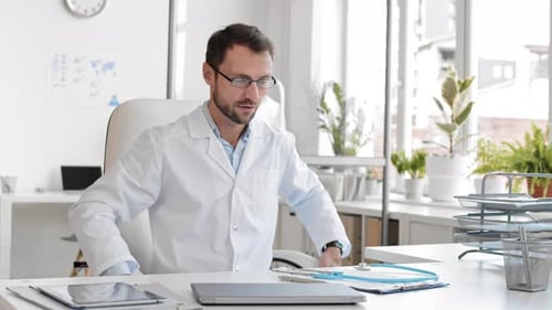 Male Doctor Puts on Stethoscope and Welcomes the Viewer