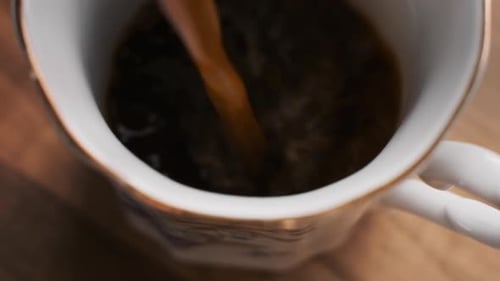 Coffee Being Poured into an Elegant Cup