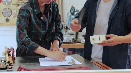 Small business concept. Two Carpenter workers working in wood factory