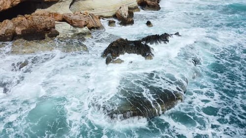 Ocean Waves Crash Against the Rocky Shore the Coastline of the Mediterranean Sea During a Storm