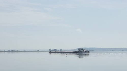 Big barge transporting goods on river Danuvbe near Brza Palanka bay 4K 2160p 30fps UltraHD footage