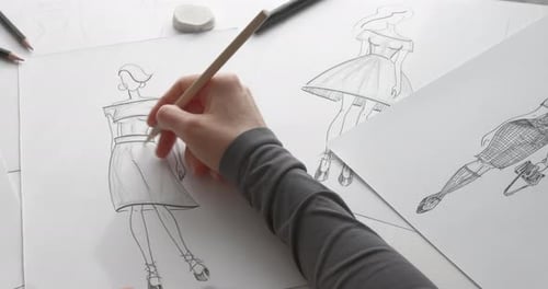Hand sketching fashion design on paper