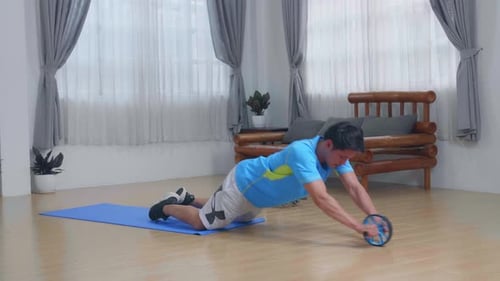 Man Working Out with Ab Roller at Home