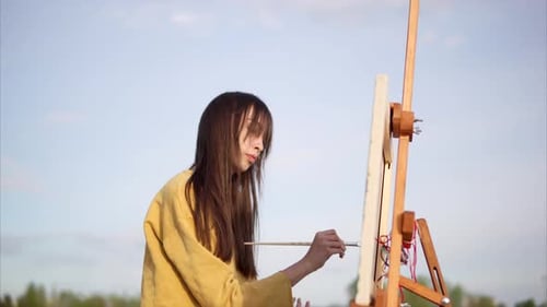 Woman Painter Drawing Picture with Oil Paint Near the Lake