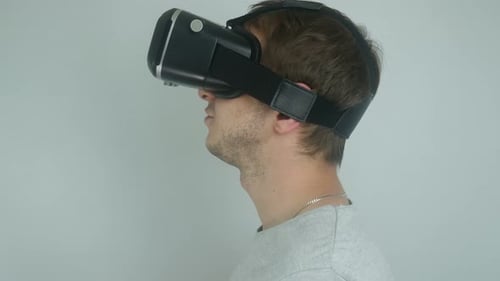 Man Wearing Virtual Reality Headset Adjusting It