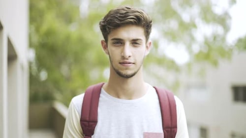 Young Man Smiling Portrait with Backpack Outdoors