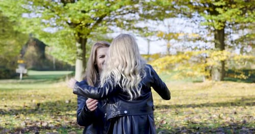 Mother and child daughter hugging and embracing at park