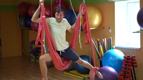 Man Stretching in Hammock for Aerial Yoga