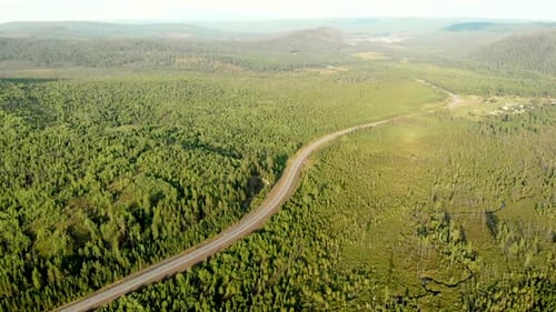 Aerial View From Drone of Village Among Forests, River and Hills, Winding Road