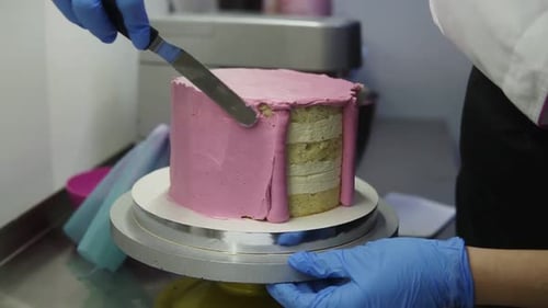 Baker Frosting Multilayer Cake with Pink Icing