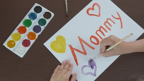 Kid with watercolors.