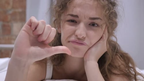 Woman Makes Heart Gesture then Thumbs Down