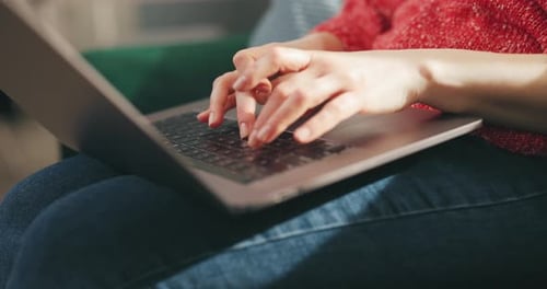 Woman Typing on Laptop at Home During Daytime