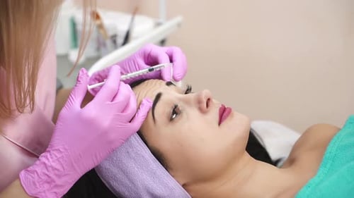 Woman Receives Forehead Injection in Medical Spa