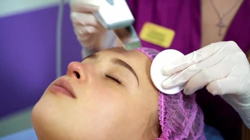 Ultrasonic scraber. Procedure of ultrasonic cleaning of face. Cosmetological clinic.