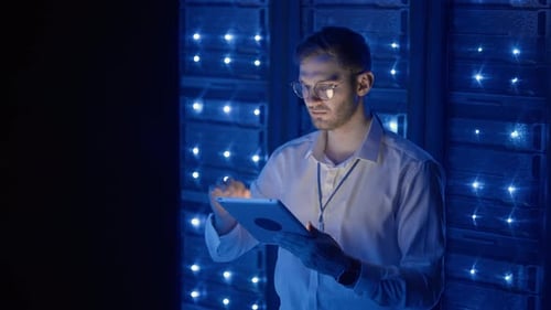 IT Technician in Data Center Digital Server Room Controlling Work of Rack Server Cabinets with a