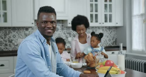 Happy Family Having Breakfast in Kitchen