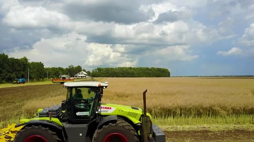 Tractor Working In The Agricultural Field. Agricultural equipment ready for ploughing the fields