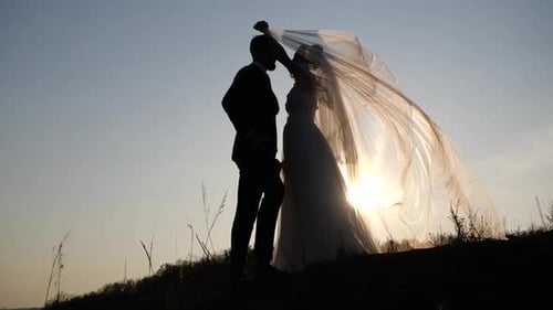 Silhouette of Bride and Groom at Sunset