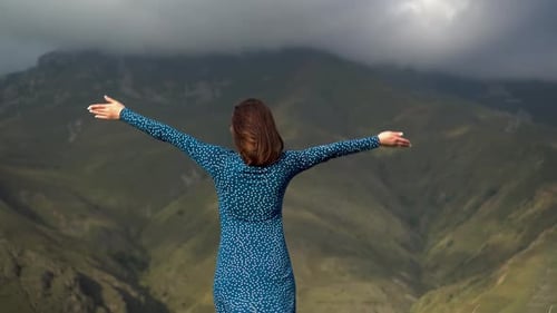 Woman Embracing Mountain View in Dress