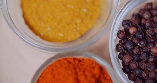 Spices in Bowls on Wooden Table