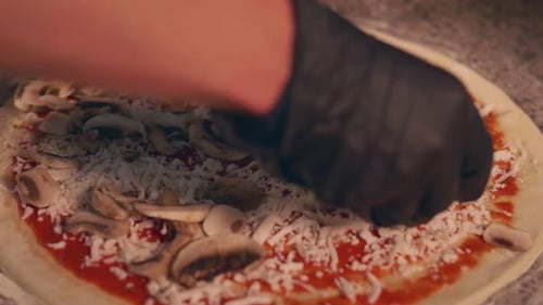 Pizza Topped with Mushrooms Being Prepared Close Up