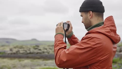 Man Takes Photo in Natural Landscape