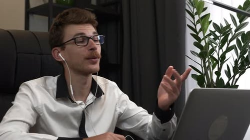 Young Man Video Conferencing on Laptop Computer