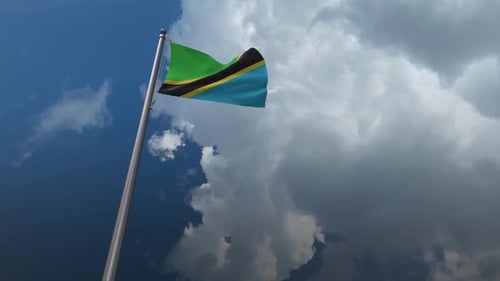 Tanzania Flag Waving in Realistic Sky with Clouds