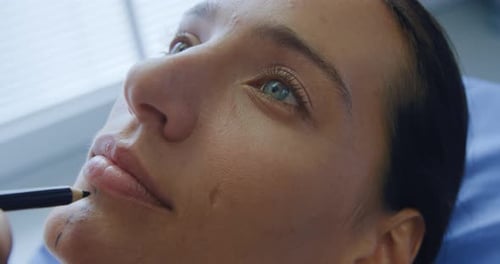 Woman Receives Cosmetic Procedure on Face