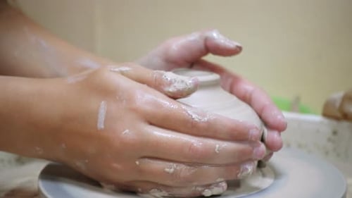 Hands Shaping Clay on Pottery Wheel