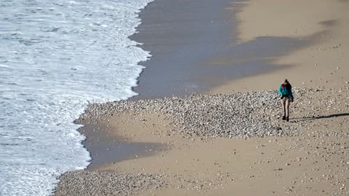 Traveler Walking Along Beach